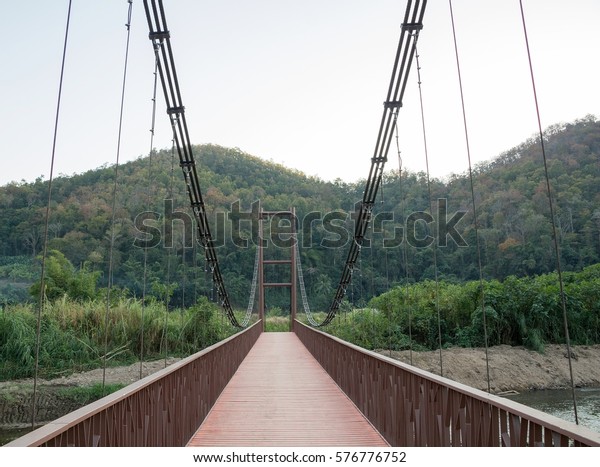 Suspension\
bridge, Crossing the river in the\
forest