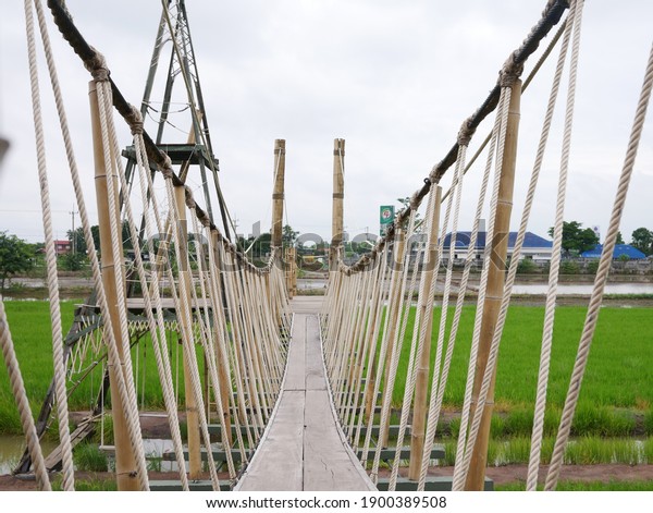 A suspension bridge
made of bamboo and rope at Rak Na Café Bang Pa-in awaits tourists
and travelers to stop for a break and have a cup of coffee.  Taken
on September 23, 2020