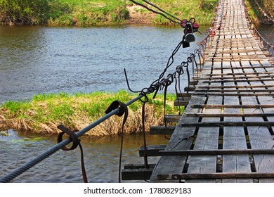 suspension bridge on steel rails across the river