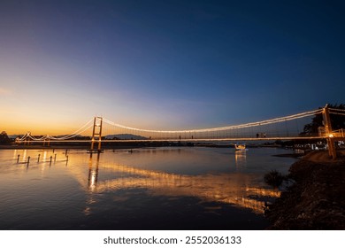 Suspension bridge over the Ping River in Tak Province, Thailand.
 - Powered by Shutterstock