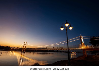 Suspension bridge over the Ping River in Tak Province, Thailand.
 - Powered by Shutterstock