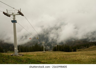 Suspension Cable Car In The Mountains. Summer In The Fog..