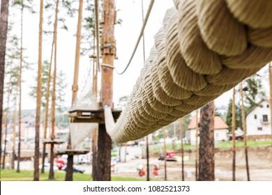Suspension hanging rope bridge in an adventure park in the woods, outdoor activity adrenaline sport activity, detail macro closeup