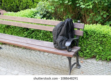 Suspicious Backpack On Bench. Threat Bag As Warning Terrorism Symbol