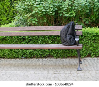 Suspicious Backpack On Bench. Threat Bag As Warning Terrorism Symbol