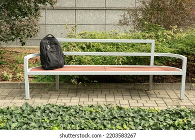 Suspicious Backpack On Bench. Threat Bag As Warning Terrorism Symbol