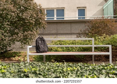 Suspicious Backpack On Bench. Threat Bag As Warning Terrorism Symbol