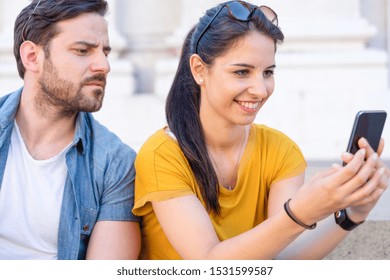 Suspicious Boyfriend Spying His Girlfriend Texting On Mobile Phone