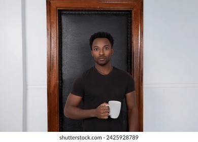 suspicious man drinking coffee cup standing in black leather door frame serious owner lifestyle - Powered by Shutterstock