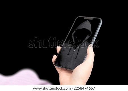 A suspicious person on the screen of a smartphone.