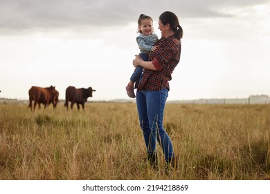 Sustainability, agriculture and countryside farm mother and daughter hug, happy family bonding in nature together. Loving parent and child having fun exploring outdoors, laughing and being playful - Powered by Shutterstock