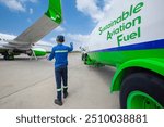 Sustainable Aviation Fuel (SAF). Technician refueling private jet with SAF at the airport.