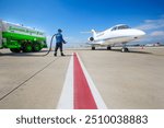 Sustainable Aviation Fuel (SAF). Technician refueling private jet with SAF at the airport.