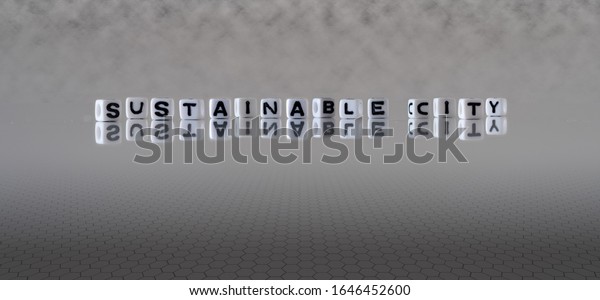 sustainable\
city concept represented by black and white letter cubes on a grey\
horizon background stretching to\
infinity