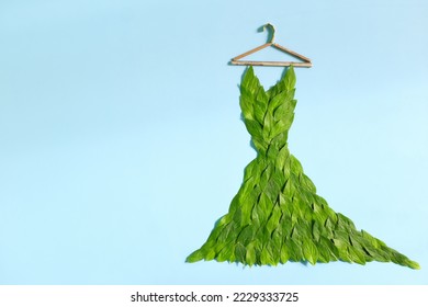 Sustainable and eco friendly fashion concept. Dress made of fresh green leaves in blue background. - Powered by Shutterstock