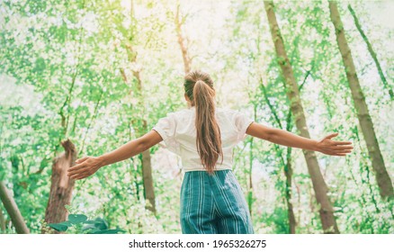 Sustainable Eco-friendly Fashion Clothes Woman Feeling Free With Open Arms In Woods Forest Happy Breating Clean Air. Travel Tourist Girl Walking In Natural Healthy Environment Renewable Resources.