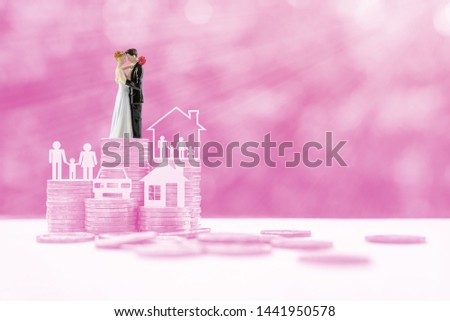 Sustainable financial goal for family life or married life concept : Miniature wedding couple, parent & child, a house or home, a car on rows of rising coins, depicts savings or growth for new family