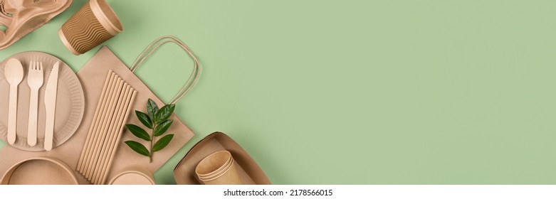 Sustainable Food Packaging - Paper Food Cups, Containers, Paper Bag, Wooden Bamboo Cutlery Set And Drinking Straws Over Green Background With Copy Space. Street Food Take Away Paper Utensils. Banner