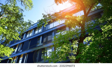 Sustainable glass office building with trees for reducing carbon dioxide. Eco-friendly building in modern city. Office with green environment. Corporate building reduce CO2.