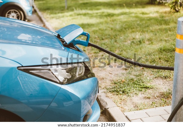 Sustainable green electric energy car. Electric\
car charging in winter. Smart city transport. Future charge station\
for environment and save the planet.\
