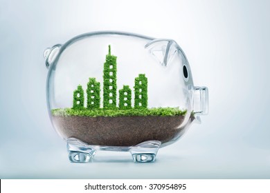 Sustainable Urban Development Concept With Grass Growing In Shape Of A City Inside Transparent Piggy Bank