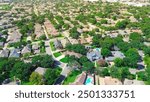 Sustainable urban planning residential neighborhood green community in North Arlington, Texas, open space reserve, road verges, lush green trees cover swimming pool houses, suburbs Dallas, aerial. USA