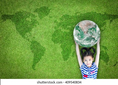 Sustainable world environment, CSR with people, ESG campaign, international children's day concept with girl kid raising earth on green lawn: Element of the image furnished by NASA