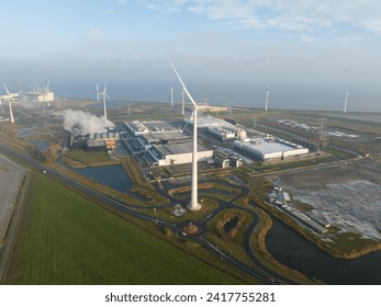 SustainableClimateVisuals Datacenter using sustainable energy produced by wind turbines. Eemshaven, The Netherlands. Aerial drone view. - Powered by Shutterstock