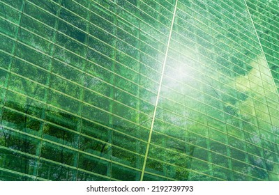 Sustainble green building. Eco-friendly building. Sustainable glass office building with tree for reducing carbon dioxide. Office with green environment. Corporate building reduce CO2. Safety glass. - Shutterstock ID 2192739793