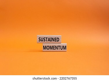 Sustained Momentum Symbol. Wooden Blocks With Words Sustained Momentum. Beautiful Orange Background. Business And Sustained Momentum Concept. Copy Space.