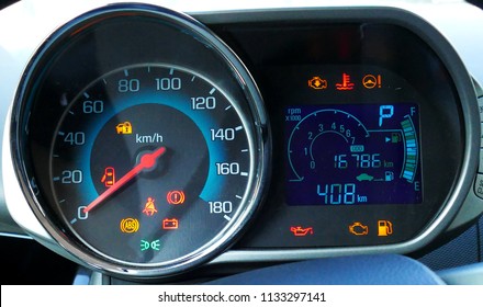 Sustem check on engine start. Speedometer and tachometer with additional instruments on car dashboard.