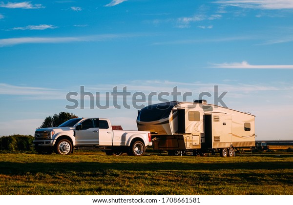 SUV camper mobile camper trailer in sunset light\
in Iceland in summer