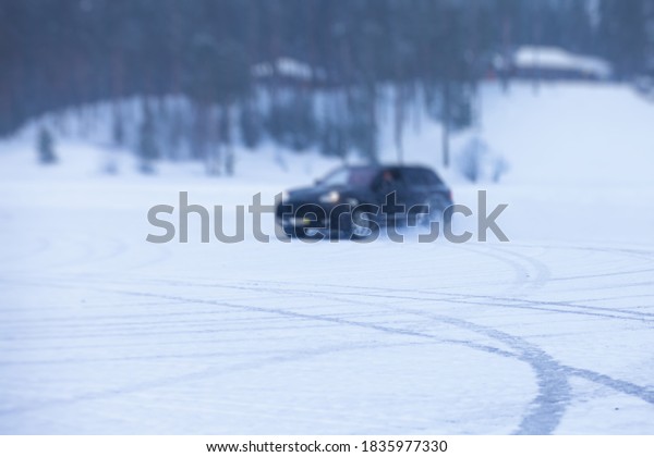 SUV car drifting in snow,\
during competition, sport car racing drift on snowy race track in\
winter.