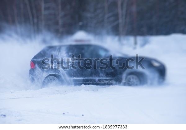 SUV car drifting in snow,
during competition, sport car racing drift on snowy race track in
winter.