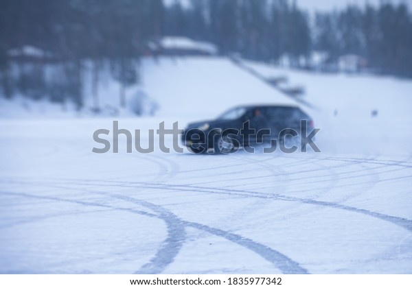 SUV car drifting in snow,\
during competition, sport car racing drift on snowy race track in\
winter.