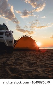 Suv Car Near Tent At Sandy Beach. Camping Lifestyle