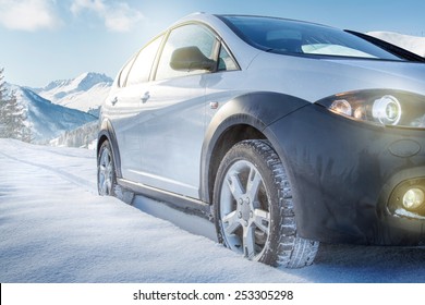 SUV Car On Snow Covered Mountain Road