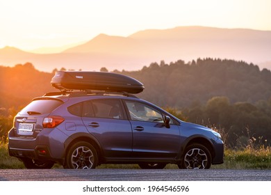 SUV Car With Roof Rack Luggage Container For Off Road Travelling Parked At Roadside At Sunset. Road Trip And Getaway Concept. Kyiv, Ukraine - September 19, 2020.