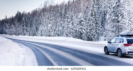 Suv Car With Rooftop Cargo Carrier Trunk Stay On Roadside Of Winter Road. Family Trip To Ski Resort. Winter Holidays Adventure. Car On Winter Road