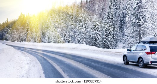 Suv Car With Rooftop Cargo Carrier Trunk Stay On Roadside Of Winter Road. Family Trip To Ski Resort. Winter Holidays Adventure. Car On Winter Road