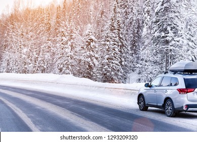 Suv Car With Rooftop Cargo Carrier Trunk Stay On Roadside Of Winter Road. Family Trip To Ski Resort. Winter Holidays Adventure. Car On Winter Road