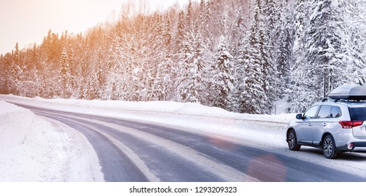 Suv Car With Rooftop Cargo Carrier Trunk Stay On Roadside Of Winter Road. Family Trip To Ski Resort. Winter Holidays Adventure. Car On Winter Road