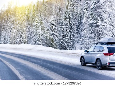 Suv Car With Rooftop Cargo Carrier Trunk Stay On Roadside Of Winter Road. Family Trip To Ski Resort. Winter Holidays Adventure. Car On Winter Road