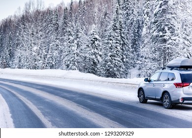 Suv Car With Rooftop Cargo Carrier Trunk Stay On Roadside Of Winter Road. Family Trip To Ski Resort. Winter Holidays Adventure. Car On Winter Road