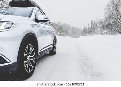 Suv Car With Rooftop Cargo Carrier Trunk Stay On Roadside Of Winter Mountain Road In Snowy Blizzard. Family Trip To Ski Resort. Winter Holidays Adventure. Car On Winter Road