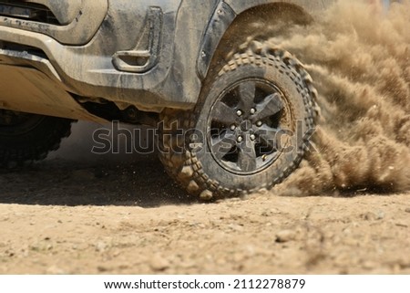 SUV off road  4WD spin mud dirty track on mountain hill.