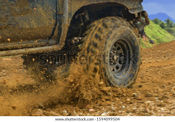 SUV\
off road  4WD spin mud dirty track on mountain\
hill.