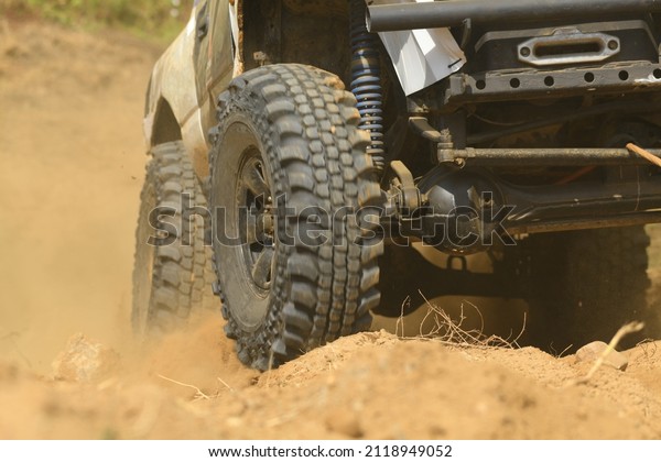 SUV\
off road  4WD spin mud dirty track on mountain\
hill.