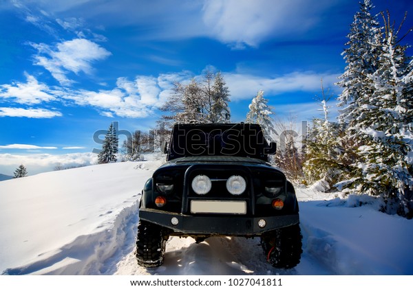 SUV on a hill in the snow.\
