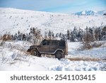 SUV in snow on the mountains. Off-road vehicle in winter snow. Off road vehicle in the winter forest, drift in the snow. SUV in a Snowstorm. Cars on off-road roads, winter off-road track.